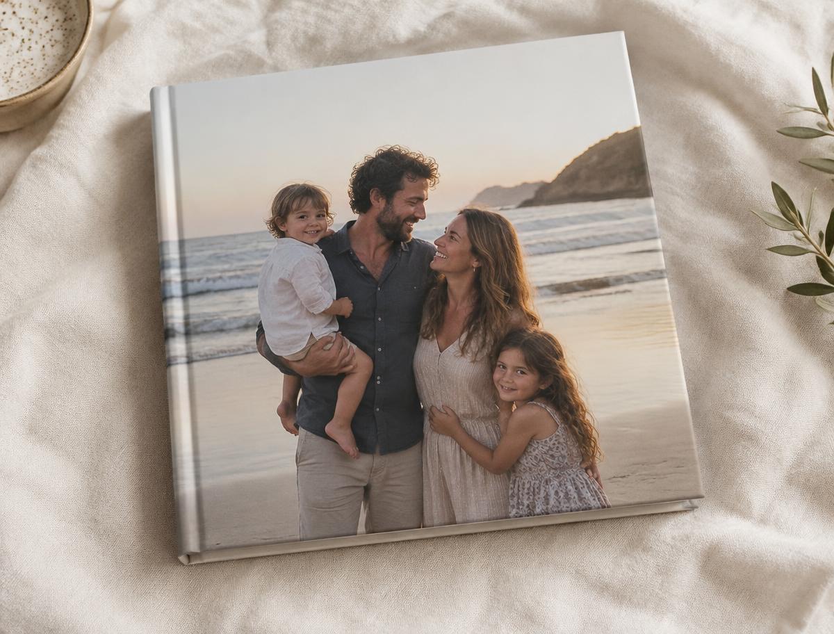 A square hardcover photo book with a family photograph on its cover